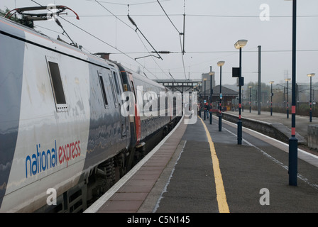 British Rail Class 91 National Express train 91111 electric locomotive Terence Cuneo at Grantham station on cloudy grey day Stock Photo