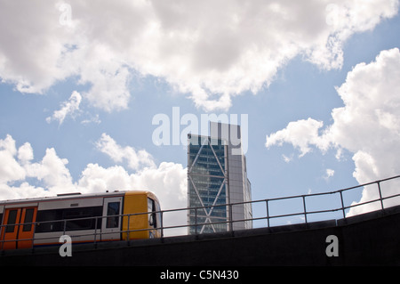 A train on the new East London Line extension passing through Shoreditch in Hackney. Broadgate Tower visible in the background. Stock Photo