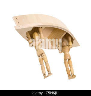 Wooden models representing people carrying a boat over their heads to the nearest lake - path included Stock Photo