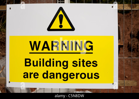 A Warning building sites are dangerous sign at a building site Nottingham England UK Stock Photo