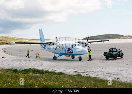 Loading luggage on a plane of Flybe - Loganair on the beach airstrip on the island of Barra in the Outer Hebrides Stock Photo