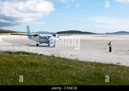 A de Havilland DHC-6 Twin Otter plane of Flybe - Loganair on the beach airstrip on the island of Barra in the Outer Hebrides Stock Photo