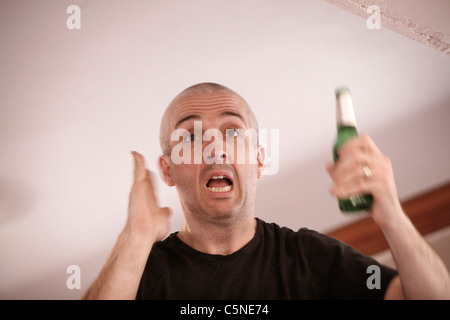 Manchester Utd unofficial song writer Peter Boyle leading the singing of Manchester Utd fans at the Bishop Blaize Pub. Stock Photo