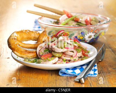 Bavarian sausage salad with pretzel Stock Photo