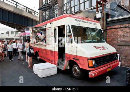 Korean BBQ taco food truck parked in Chelsea neighborhood serving customers under High Line elevated park Chelsea New York City Stock Photo