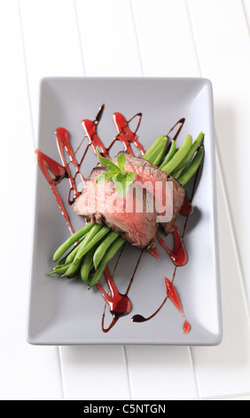 Slices of roast beef and string beans Stock Photo