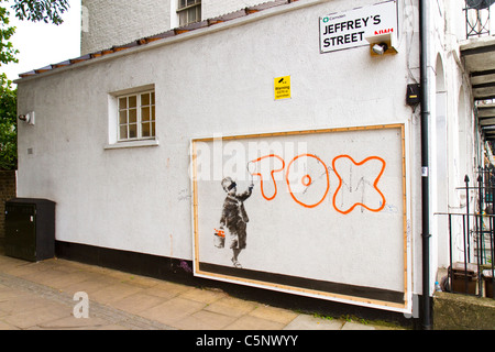 Graffiti art by street artist Banksy which mentions another graffiti writer, Tox, on a wall in Camden Town, London, UK. Stock Photo