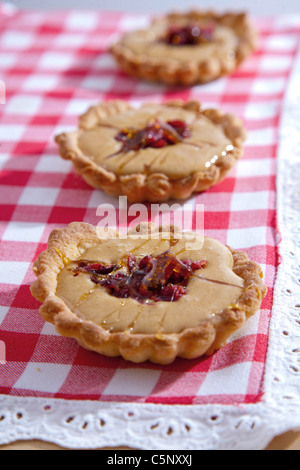 Shortcrust pastry tarts with sweet condensed milk and cranberries Stock Photo