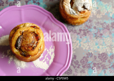 Pecan and  apricots buns on a pinky plate Stock Photo