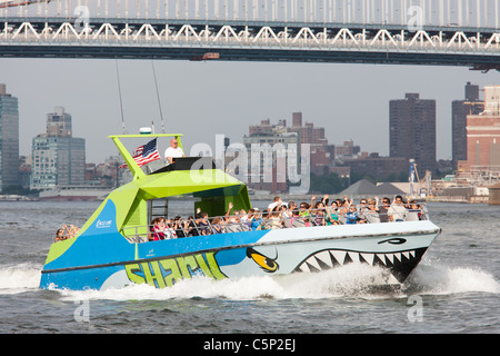 Circle Line Shark speedboat on the East River approaching its stop at South Street Seaport Pier 16 in New York City. Stock Photo