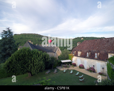 Hot air ballooning over Le Manoir, Les Milandes village. St Cyprien. Dordogne France Stock Photo