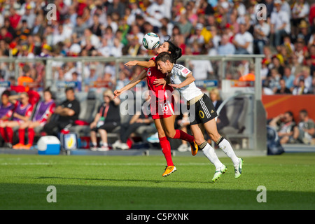 Jonelle Filigno of Canada (l) and Linda Bresonik of Germany vie for the ball during the opening match of the Womens World Cup. Stock Photo