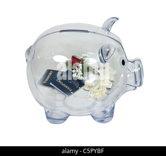 Honeymoon savings shown by a piggy bank in profile with passports with a corsage and boutonnière inside - path included Stock Photo