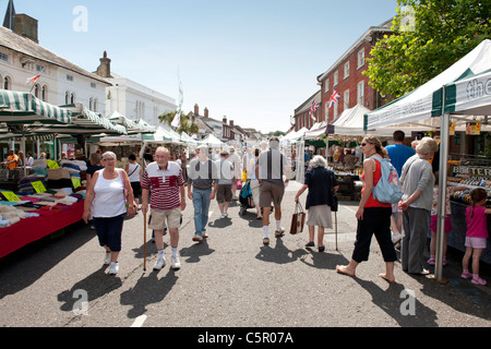Shoppers stroll around a street market in Christchuch, Dorset, on a warm summer’s day. Stock Photo