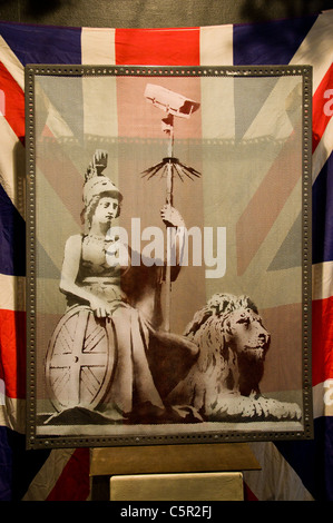 Banksy picture of Britannia holding a CCTV camera against a union jack, Bristol, England Stock Photo