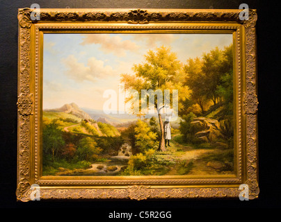 Banksy picture of lunched Ku Klux Klan member hanging from tree in classic rural painting Stock Photo