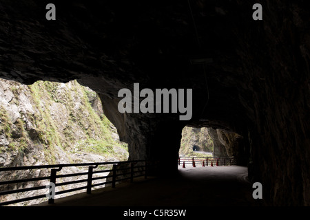Cliffside tunnel's galleries, road under rock overhang along marble canyons, Tunnel of Nine Turns, Taroko National Park, Hualien, Taiwan Stock Photo