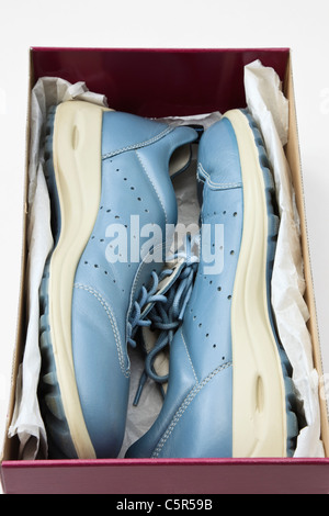 Top down of a pair of women's new blue casual laced shoes side by side in a shoe box Stock Photo