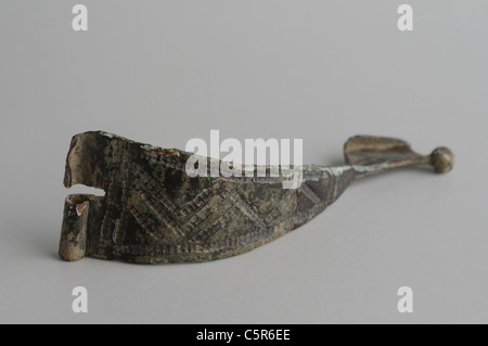 Fibula arc cast bronze decorated with notches or face side. ( 5 th CE ) - Hispanicroman  period in Complutum . SPAIN Stock Photo