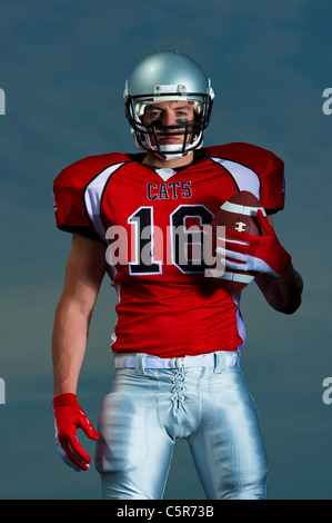 American Football player portrait with ball. Stock Photo