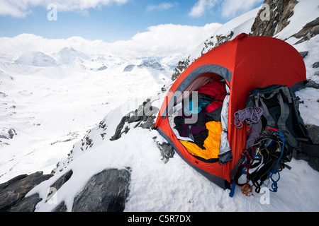A mountaineers tent on the edge of a high alpine mountain. Stock Photo