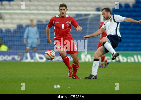 Wales and Scotland at the new Cardiff City Stadium : Wales' Ched Evans is caught by Scotlands  James McFadden. Stock Photo
