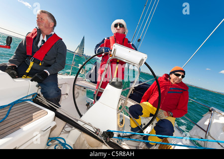 The captain at the wheel of an Ocean going yacht during race. Stock Photo