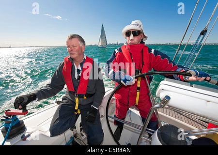The captain is steering an Ocean going yacht. Stock Photo
