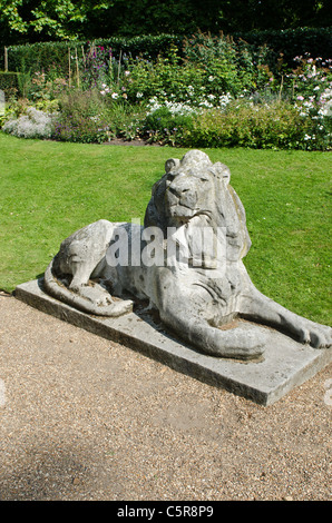 Stone Lion with garden border behind Clarence House The Mall Westminster London Uk Stock Photo