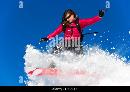 A Snowboarder riding fresh powder snow. Stock Photo