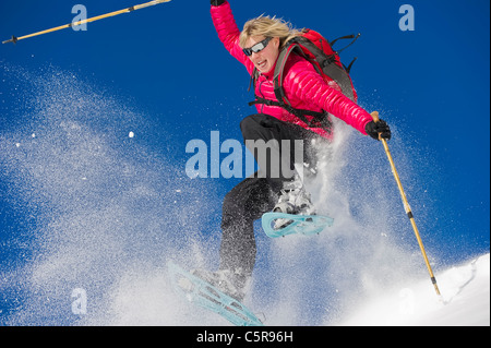 Having fun and snowshoeing through deep fresh powder snow. Stock Photo