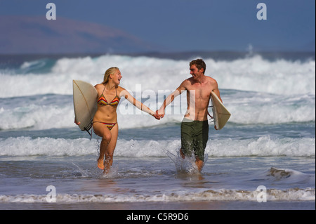 A couple having fun in the surf. Stock Photo