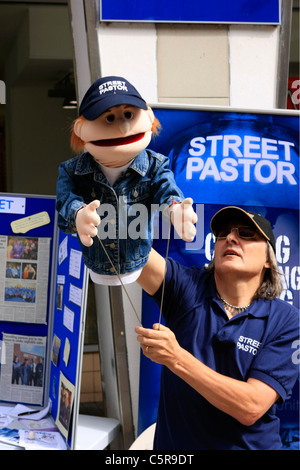 Street Pastor spreading the word of God using a Puppet Stock Photo