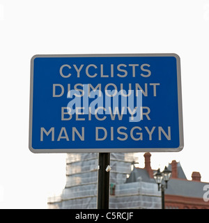 Bilingual cyclists dismount sign in both Welsh and English languages in Cardiff. Stock Photo
