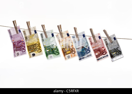Different Euro bank notes hanging on clothesline Stock Photo