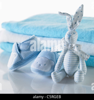 Baby's shoes and a doll Stock Photo