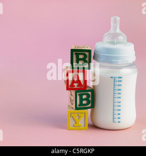 Toy blocks and a baby bottle Stock Photo