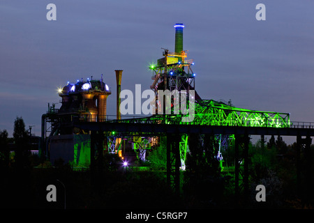 Germany Illuminated blast furnace and smoke stacks of old industrial plant Stock Photo