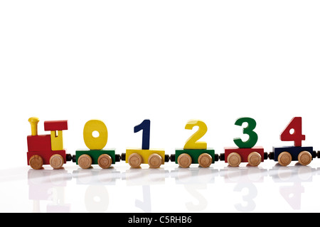 Colourful wooden toy train with figures Stock Photo