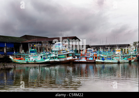 fishing boats at low tide in the harbor channel Thailand Stock Photo