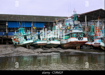 fishing boats beached during low tide Stock Photo