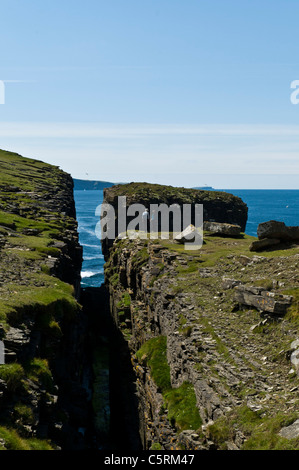 dh  ROUSAY ORKNEY Tourist hikers Rousay north coast seacliffs and coastal sea stack cliff erosion cliffs scotland Stock Photo