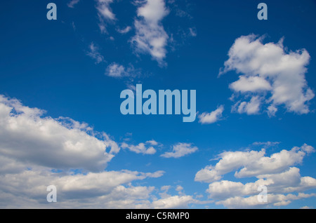 A bright blue sky with puffy white clouds Stock Photo