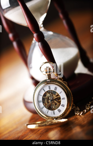 Gold pocket watch and hourglass Stock Photo