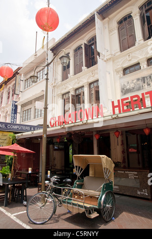 Bicycle rickshaw in front of Chinatown Heritage Center, Chinatown, Singapore, Southeast Asia, Asia Stock Photo