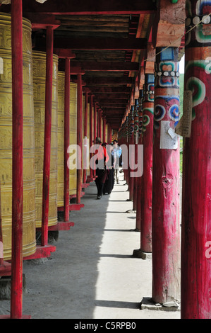 Tibetan prayer wheels along a corridor. Tagong, Sichuan, China. Stock Photo