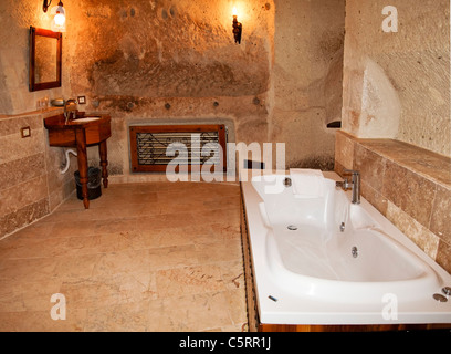 renovation of a bathroom with bathtub, marble floor, limestone walls in cappadocia cave Stock Photo