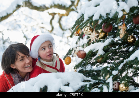 Austria, Salzburg Country, Flachau, Young mother and daughter looking at christmas tree Stock Photo