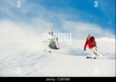 Austria, Salzburg Country, Altenmarkt-Zauchensee, Mid adult couple skiing on ski slope in winter Stock Photo