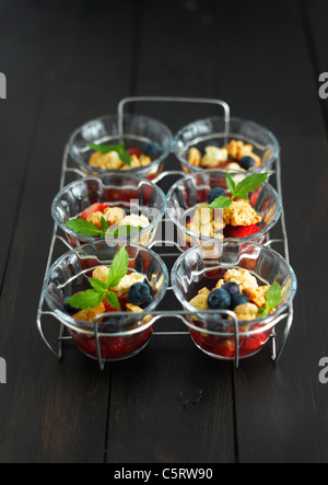 Close up of strawberry crumble with blueberries on tray Stock Photo